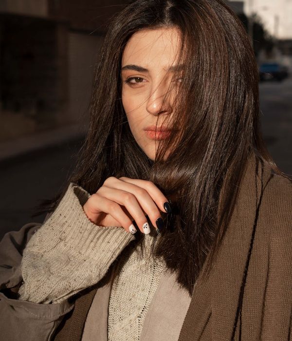 Woman feeling energized and happy in a calm setting.